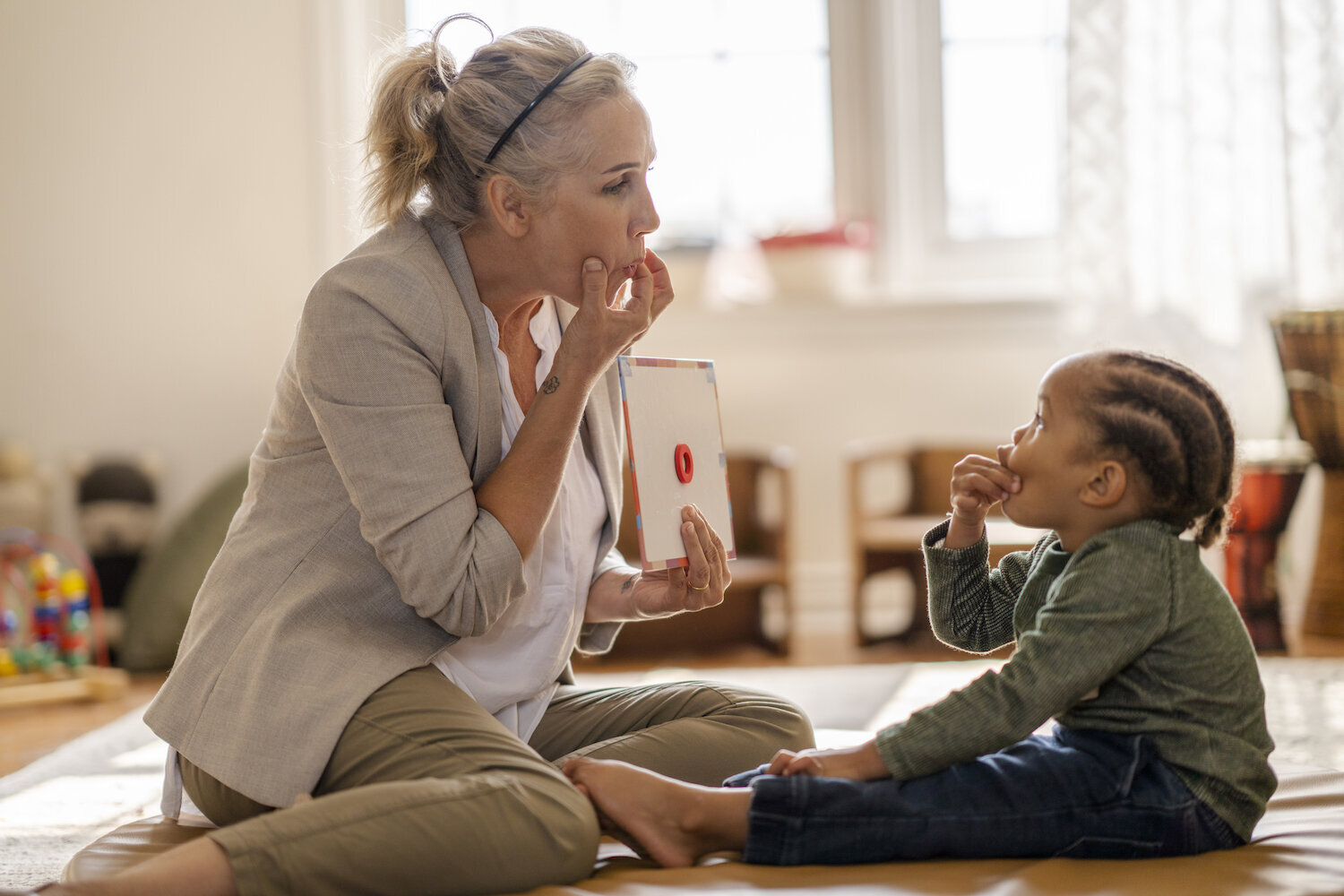 Speech therapist practicing sounds with a child